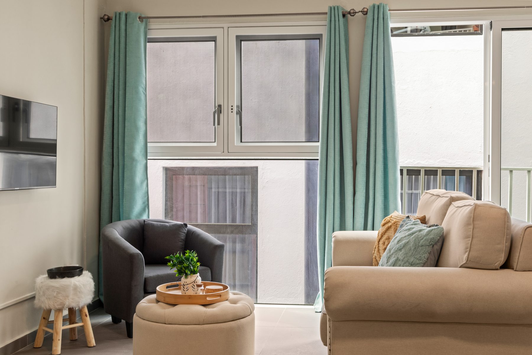 The Bridge: middle-floor living room with sofa and armchair, looking out over the old town